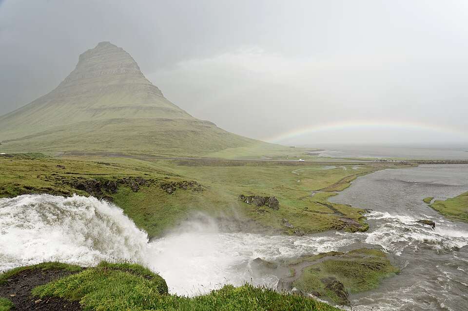 Kirkjufell and Kirkjufellsfoss under a rainbow